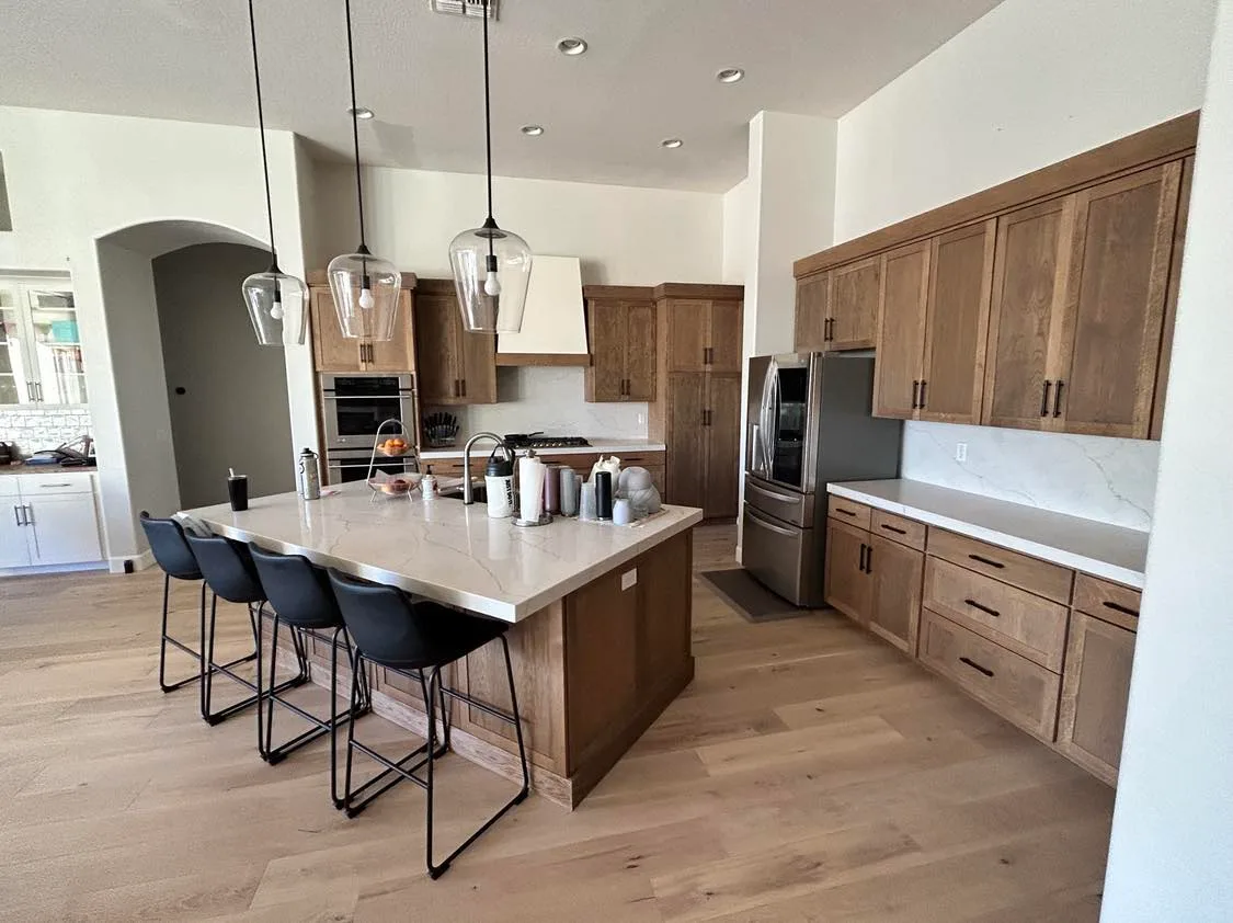 Kitchen cabinetry and built-in oven with brass pulls