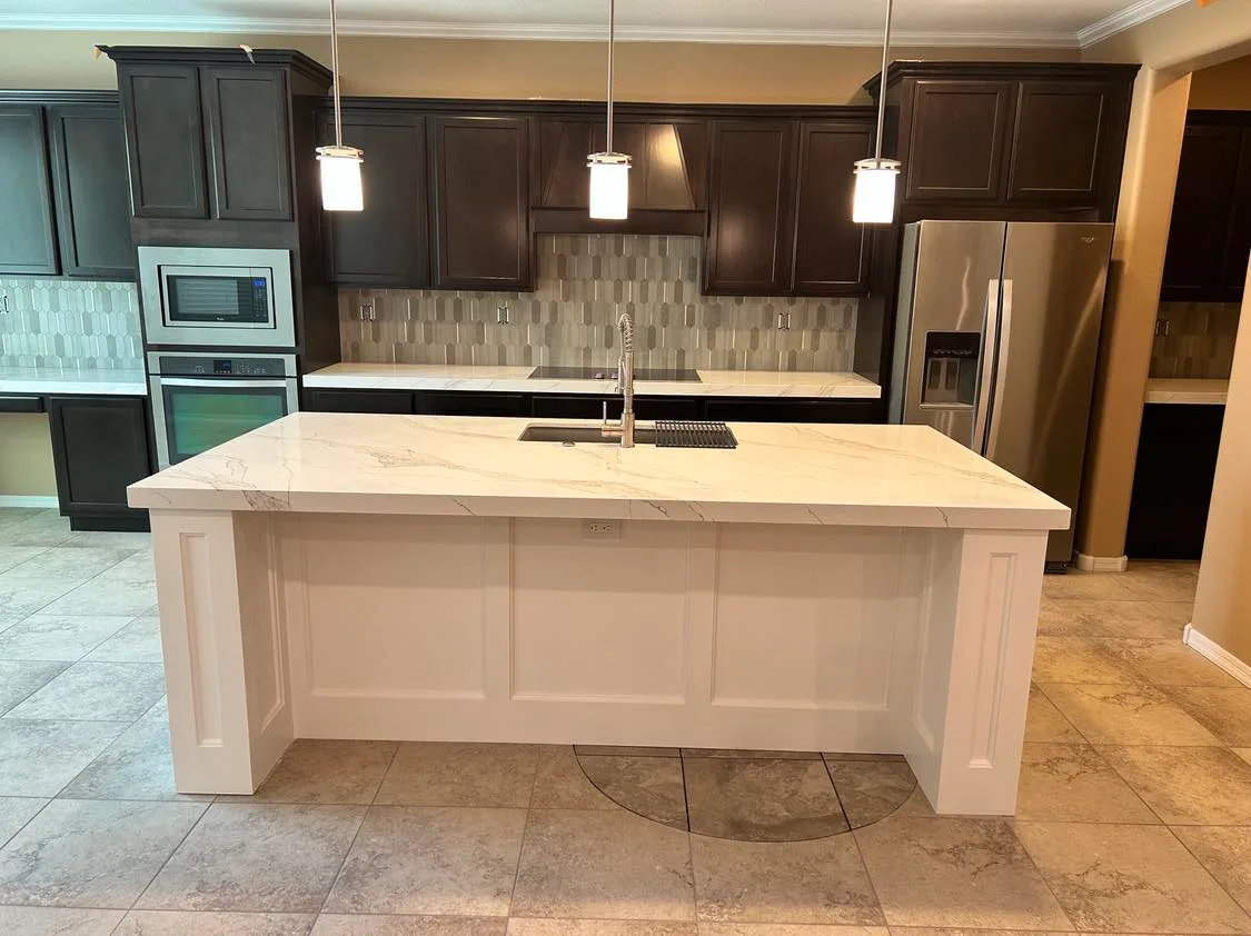 Remodeled kitchen with stainless appliances and tile backsplash